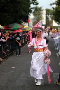 People performing on street in city