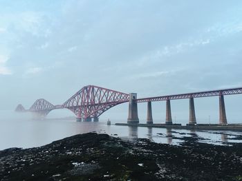 Forth bridge over sea against sky