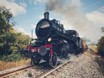 Train on railroad track against sky