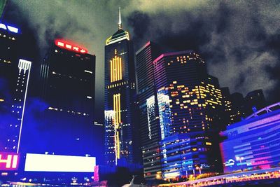 Low angle view of modern building against sky at night