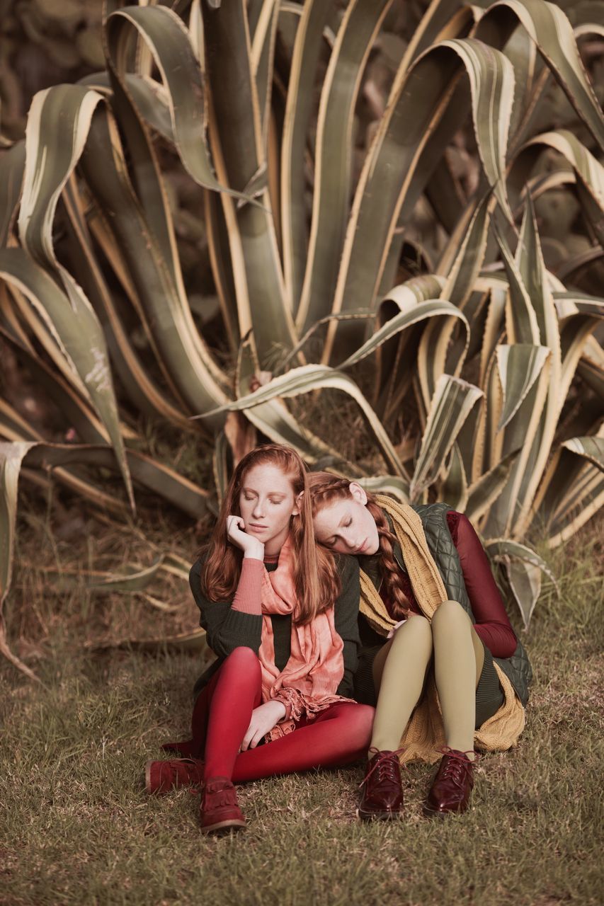 two people, full length, girls, childhood, sitting, casual clothing, togetherness, real people, day, friendship, outdoors, blond hair, grass, people