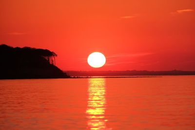 Scenic view of sea against romantic sky at sunset