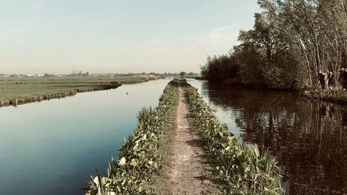 Scenic view of canal against sky