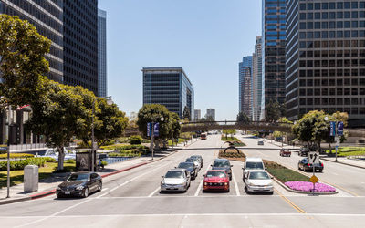 Cars at street in city on sunny day