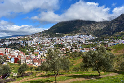 View of townscape by mountain against sky