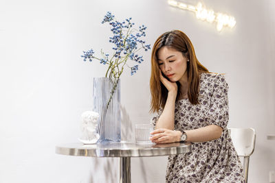 Young woman sitting on table