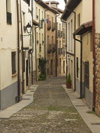 Narrow street amidst buildings in town