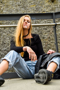 Portrait of young woman sitting outdoors