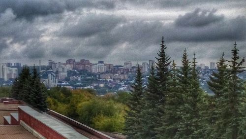 City buildings against cloudy sky