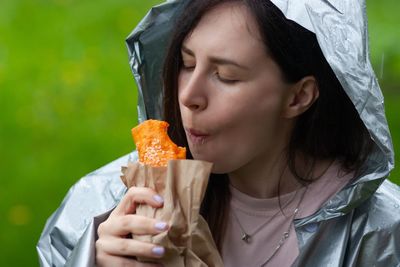 Close-up portrait of woman eating food