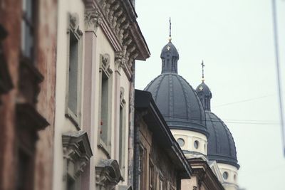 Low angle view of church in city against sky