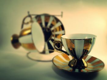 Close up of coffee cup with saucer on table