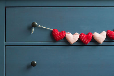 Close-up of heart shape decoration hanging on drawer