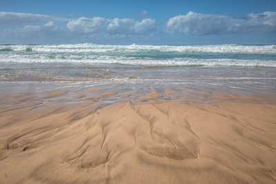 Scenic view of beach against sky