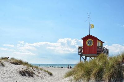 Lifeguard hut on beach against sky