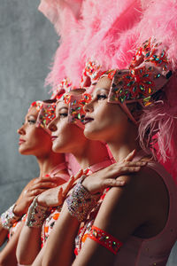 Samba dancers standing against wall