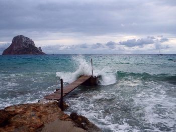 Scenic view of sea against cloudy sky