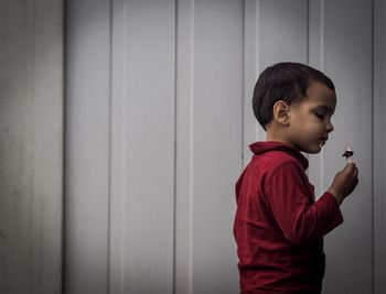 Boy standing in front of wall