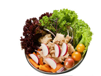 Close-up of vegetables in plate against white background