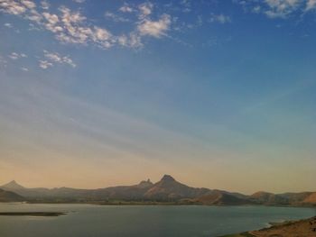 Scenic view of mountains against blue sky