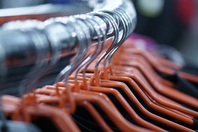 Close-up of coathangers on rack