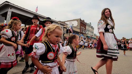 Group of people in traditional clothing against sky