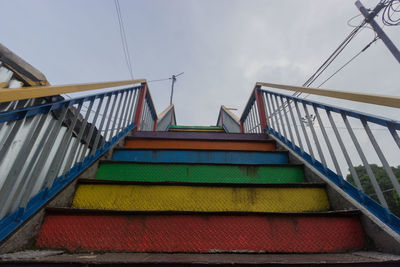 Low angle view of staircase by building against sky