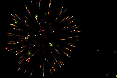 Low angle view of firework display at night