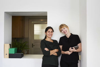 Portrait of confident businesswomen smiling in office