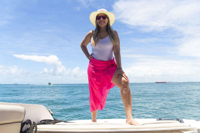 A woman on top of a boat against the sea in the background. salvador, bahia, brazil.