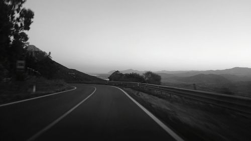 Empty road leading towards mountains