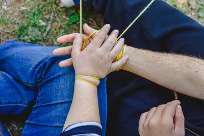 Cropped image of father and son tied up