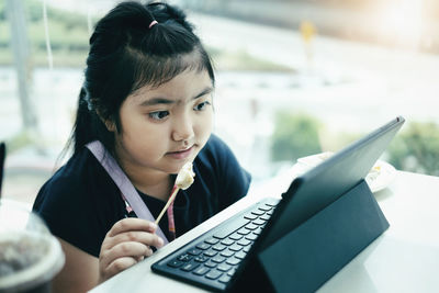 Portrait of girl sitting on mobile phone