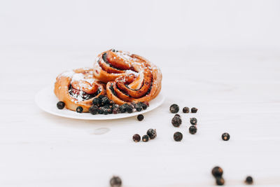 Close-up of cake on table against white background
