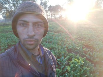 Portrait of young man against trees