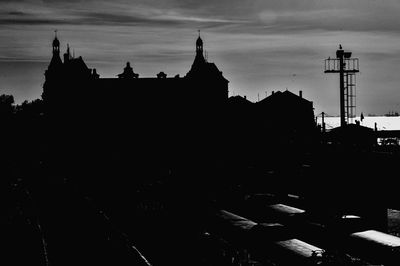High section of silhouette built structures against sky