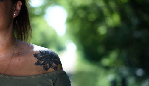 Close-up of woman with tattoo on shoulder