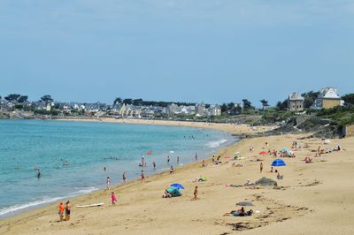 People on beach against sky