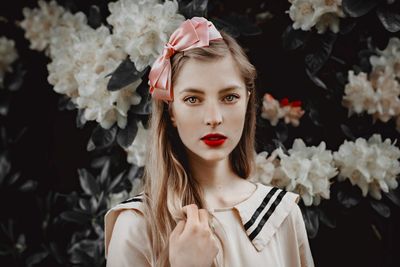 Portrait of woman holding flower