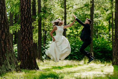 Woman playing with umbrella in forest