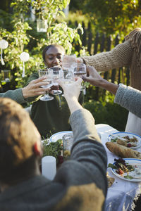 Hands with wineglasses toasting