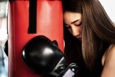 Young woman practicing boxing in gym