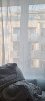 Man relaxing on bed by window at home