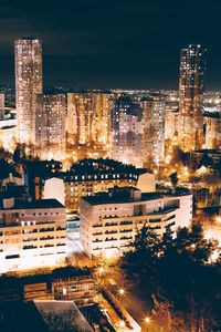 High angle view of illuminated cityscape against sky at night