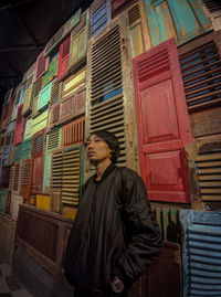 Low angle view of woman standing against building