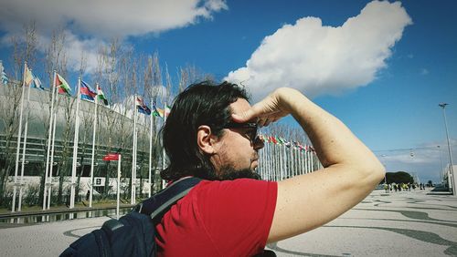 Portrait of young man against sky