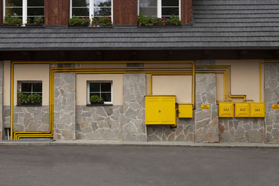 Yellow pipes on wall of house