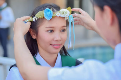 Close-up of young woman holding flower