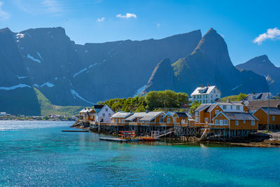 Scenic view of sea and mountains against sky