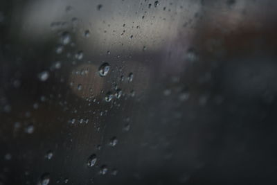 Full frame shot of wet glass window during rainy season